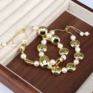 Adjustable gold bead and pearl bracelet with vintage minimalist pull-chain design