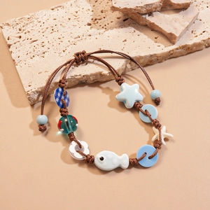 Blue ceramic ocean star fish beaded woven bracelet on natural stone background