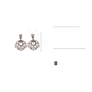 Detail view of pearl and rhinestone earrings showing dimensions of 2.5cm by 5cm