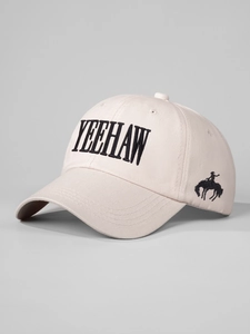 Detailed close-up of Yeehaw embroidery and cowboy silhouette on off-white cotton baseball cap