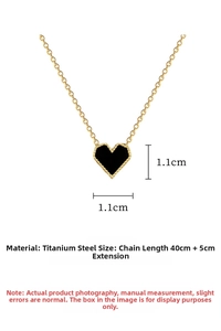 Detail of titanium steel heart pendant with black inlay and golden beaded edges