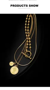 Macro shot of gold layered coin necklace with OT toggle clasp on black tray