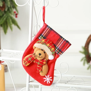 Red Christmas stocking with teddy bear ornament and black-red buffalo plaid cuff