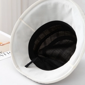 Detail of white sun hat interior with black breathable mesh lining and adjustable drawstring