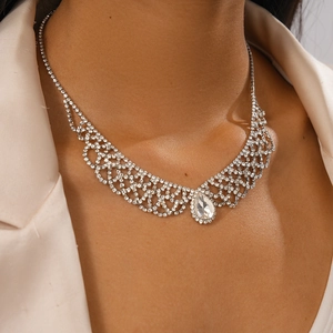 Detail of luxury water-drop pendant necklace with crystal grid pattern on elegant model