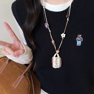 Artistic fabric pendant necklace with wood beads and embroidered coffee bag charm