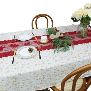 Christmas red lace table runner with bell patterns on a white and gold festive tablecloth