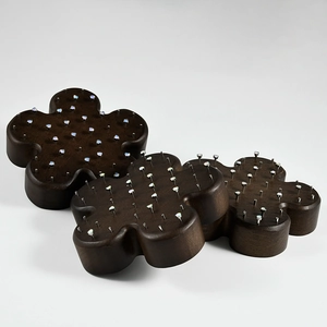 Three-piece dark brown floral wooden jewelry display stands with opal-colored stud accents