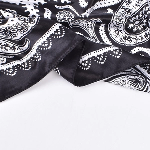 Detail of paisley print silk-like satin square scarf with rolled hem edges