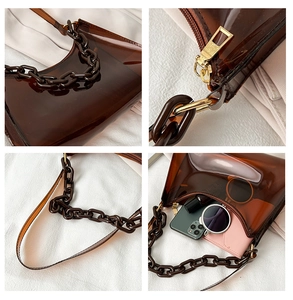 Detailed view of brown transparent PVC shoulder bag with chunky chain and inner pouch