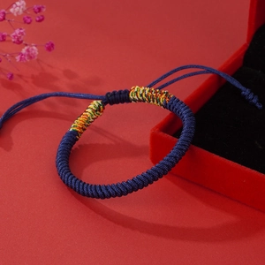 Handmade woven navy blue cord bracelet with colorful beads in a luxury velvet gift box