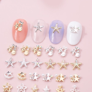 Mix of gold and silver starfish and shell charms with pearls for DIY 3D nail art design