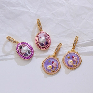 Macro view of purple enamel flower pendants with pearls and crystals on white background