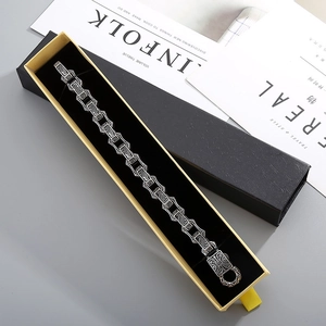 Vintage silver engraved bracelet displayed in a premium yellow drawer jewelry gift box