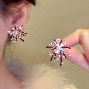 Macro shot of red enamel fireworks stud earrings with pearls and crystals