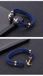 Detail of blue nylon woven rope bracelet with gold stainless steel anchor clasp