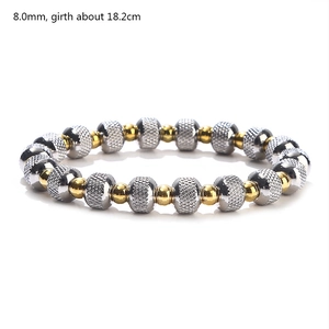 Detail of 8mm dual-tone steel beads with knurled silver and polished gold texture
