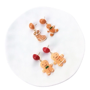 Asymmetric handmade Christmas earrings set featuring gingerbread man and stocking charms