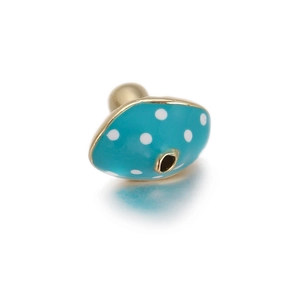 Macro shot of blue enamel mushroom charm with white dots and gold plating for jewelry DIY