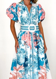 Detailed view of bohemian floral maxi dress with button-up V-neck and puff sleeves