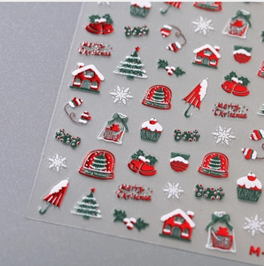 Macro detail of 3D Christmas nail stickers with red and green festive motifs