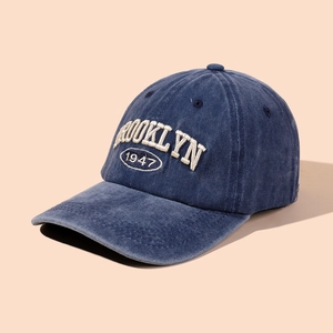 Detail view of the Brooklyn 1947 3D embroidery on this washed blue retro baseball cap