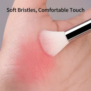 Transparent handle eye makeup brush set showing soft white bristles on skin