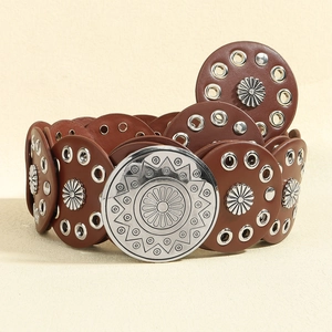 Detail of bohemian brown leather disk belt with silver flower rivets and carved buckle