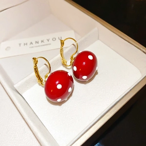 Elegant gold-plated pearl drop earrings with red polka dot design in a white gift box