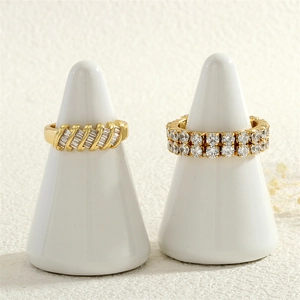 Detailed macro view of 18K gold plated zircon rings on white display stands