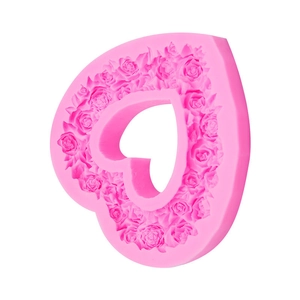 Pink heart-shaped silicone mold with rose flower embossing for fondant and chocolate