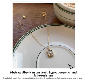 Close-up of titanium steel rabbit necklace with white shell pendant on a porcelain plate
