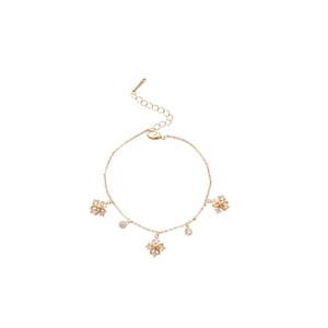 Elegant gold bracelet featuring zircon Saturn and flower charms with an adjustable clasp