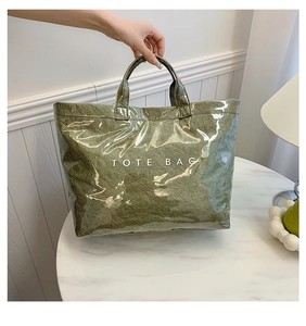 Close-up of olive green waterproof DuPont paper tote bag with clear PVC outer layer