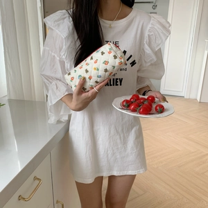Detailed close-up of quilted floral pencil case with bear patterns held by model