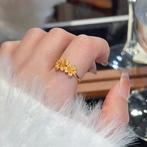 Detailed macro view of 24k gold plated flower ring with brushed texture petals