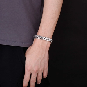 Detailed close-up of heavy double-row dragon bone weave stainless steel bracelet for men