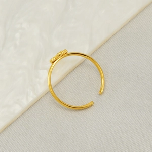 Detailed side view of 18k gold plated stainless steel clover ring with adjustable band