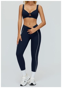 Dettaglio dei leggings da yoga blu navy con strisce bianche laterali a contrasto
