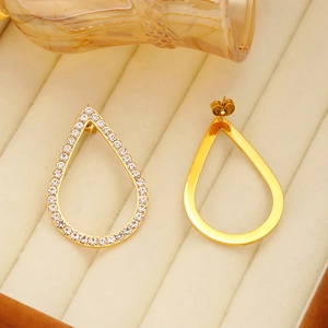 Elegant gold teardrop earrings with white zircon micro-paving on soft velvet background