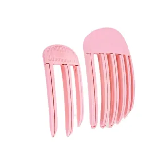 Set of 2 pink hair root volume clips for natural hair styling on a white background