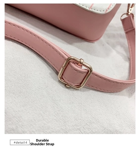 Detail of durable pink PU leather shoulder strap with adjustable light gold metal buckle