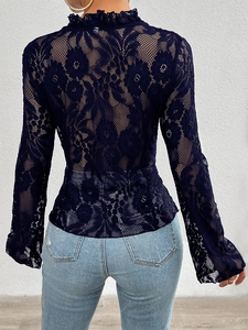 Detail view of the floral mesh lace back and ruffled high neck on a navy long sleeve top