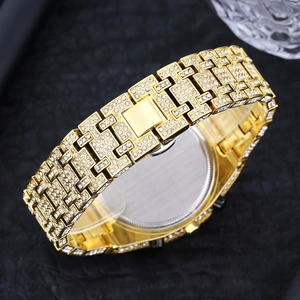 Macro shot of gold hip hop watch strap featuring dense rhinestone paving and clasp