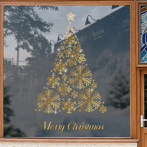 Golden snowflake Christmas tree window sticker with Merry Christmas lettering on glass