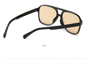 Detail view of large pilot sunglasses with black frame, orange lenses and double bridge
