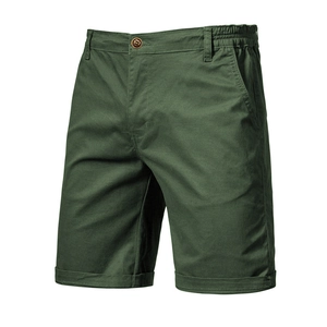 Detail of dark green cotton shorts showing the elastic waistband and twill texture