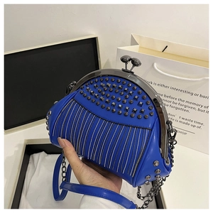 Close-up of blue PU leather bag with black rivets and silver rhinestone chain details