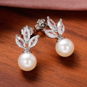 Macro shot of S925 silver earrings with marquise cubic zirconia and a white pearl