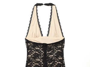 Detail of black lace halter dress featuring deep V-neckline and sheer floral pattern